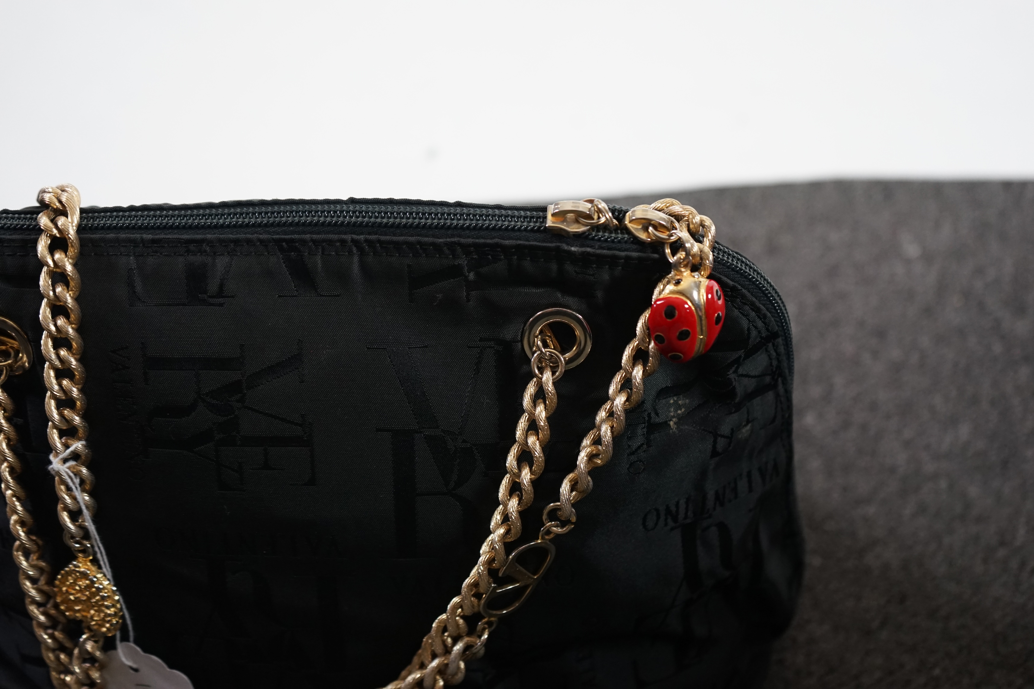 A selection of lady's handbags including a VERY Valentino black canvas bag with gold decorated chain handles, a Mary Frances black suede faux snake skin print shoulder bag with embellished fastening, a tan suede shoulder